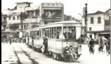 Trẻ em b�m t�u ba toa đi k� về c�c ngả trong th�nh phố. Ảnh tư liệu