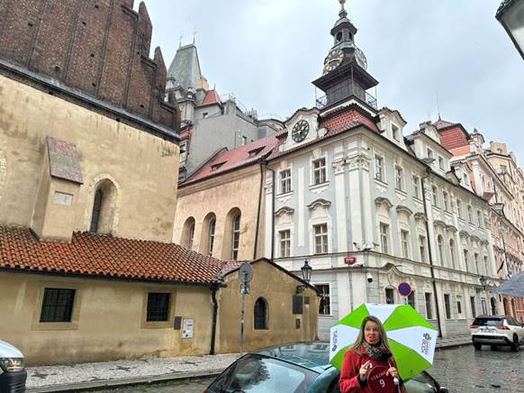 A person holding an umbrella in front of a building

AI-generated content may be incorrect.