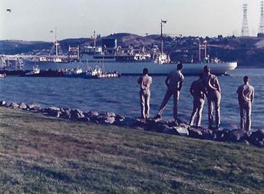 A group of men standing on a rock by the water

AI-generated content may be incorrect.